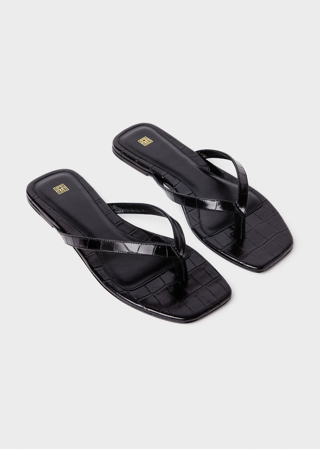 Croco-embossed flip flops black